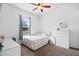 Clean and modern bedroom with neutral walls, ceiling fan, updated window, and a comfortable bed at 245 Meadow Bay Ct, Lake Mary, FL 32746
