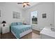 Cozy bedroom with neutral walls, ceiling fan, ample natural light, and coordinated decor at 245 Meadow Bay Ct, Lake Mary, FL 32746