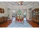 Elegant dining room with tray ceiling, hardwood floors, and views of the foyer, a perfect space for dinners at 245 Meadow Bay Ct, Lake Mary, FL 32746