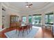 Elegant dining room with tray ceiling, hardwood floors, and views of the pool, great for entertaining at 245 Meadow Bay Ct, Lake Mary, FL 32746