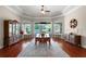 Elegant dining room with tray ceiling, hardwood floors, and views of the pool, great for entertaining at 245 Meadow Bay Ct, Lake Mary, FL 32746