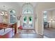 Bright entryway features tile flooring and an arched window, creating a welcoming and elegant atmosphere at 245 Meadow Bay Ct, Lake Mary, FL 32746