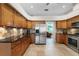 Well-lit kitchen with stainless steel appliances and granite countertops at 245 Meadow Bay Ct, Lake Mary, FL 32746