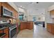 Modern kitchen featuring stainless steel appliances and seamlessly opening up to the spacious living area at 245 Meadow Bay Ct, Lake Mary, FL 32746