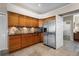 Well-lit kitchen featuring stainless steel refrigerator, granite counters, and tile backsplash at 245 Meadow Bay Ct, Lake Mary, FL 32746