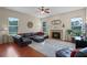 Cozy living room features a fireplace, plush seating, and ample natural light from large windows at 245 Meadow Bay Ct, Lake Mary, FL 32746