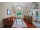 Inviting living room with a large arched window, piano, and ample natural light, ideal for relaxing and entertaining at 245 Meadow Bay Ct, Lake Mary, FL 32746