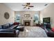 Inviting living room with fireplace, ceiling fan, and a plush rug over hardwood floors at 245 Meadow Bay Ct, Lake Mary, FL 32746