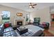 Comfortable living room featuring a fireplace, soft rug, and a glimpse of the kitchen at 245 Meadow Bay Ct, Lake Mary, FL 32746
