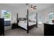 Spacious bedroom with a four-poster bed, fan, and plenty of natural light at 245 Meadow Bay Ct, Lake Mary, FL 32746