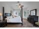 Big bedroom with four-poster bed, fan, pool view, and dark wooden furniture at 245 Meadow Bay Ct, Lake Mary, FL 32746
