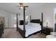 Large bedroom with a four-poster bed, fan, and seating area in view at 245 Meadow Bay Ct, Lake Mary, FL 32746