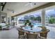 Inviting covered patio with dining area, comfortable wicker furniture, and clear view of the pool at 245 Meadow Bay Ct, Lake Mary, FL 32746