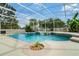 Sparkling screened-in pool with a spa, lush landscaping, and ample space for relaxation and recreation at 245 Meadow Bay Ct, Lake Mary, FL 32746