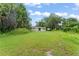 Large backyard with mature trees, offering plenty of space for outdoor activities at 247 Toms Rd, Debary, FL 32713