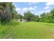 Large backyard with mature trees, offering plenty of space for outdoor activities at 247 Toms Rd, Debary, FL 32713
