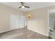 Bedroom with wood-grain flooring, closet, sconce lighting, and bathroom access at 247 Toms Rd, Debary, FL 32713