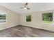 Bright bedroom with wood grain flooring and multiple windows providing ample natural light at 247 Toms Rd, Debary, FL 32713