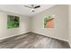 Neutral bedroom with wood-grain flooring, and bright windows with natural light at 247 Toms Rd, Debary, FL 32713