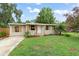 Charming single-story home with a well-kept lawn, complemented by lush landscaping and a welcoming front entrance at 247 Toms Rd, Debary, FL 32713