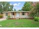 Charming home featuring a well-manicured lawn and decorative shutters, blending modern updates with a touch of natural beauty at 247 Toms Rd, Debary, FL 32713