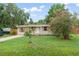 Beautiful single-story home with a lush front yard and decorative shutters on the windows at 247 Toms Rd, Debary, FL 32713