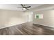 Spacious living area with modern flooring, natural light, and a ceiling fan, perfect for relaxing and entertaining guests at 247 Toms Rd, Debary, FL 32713