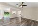 Open-concept living space with sleek flooring and ample natural light, seamlessly connecting to the outdoors and adjacent rooms at 247 Toms Rd, Debary, FL 32713