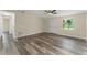Bright living room featuring stylish wood flooring and ample natural light, creating a warm and inviting space at 247 Toms Rd, Debary, FL 32713