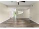 Bright living room featuring stylish wood flooring, neutral paint, and a ceiling fan, creating a warm and inviting space at 247 Toms Rd, Debary, FL 32713