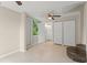 Spacious open-plan living room featuring tile flooring, ceiling fans and multiple closets at 247 Toms Rd, Debary, FL 32713