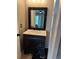 Bathroom boasts a vanity with dark cabinetry, sleek sink, and framed mirror at 2592 Grassy Point Dr # 306, Lake Mary, FL 32746