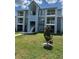 Multi-level condominium building with balconies and blue exterior paint and well-manicured lawn at 2592 Grassy Point Dr # 306, Lake Mary, FL 32746