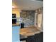 Kitchen with stone accent wall with cabinets and a microwave to give this space some flare at 2592 Grassy Point Dr # 306, Lake Mary, FL 32746