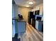 Kitchen with black appliances and wood floor offers a modern look and feel with potential for upgrades at 2592 Grassy Point Dr # 306, Lake Mary, FL 32746