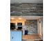 An unfinished kitchen features stone accent walls, white cabinets, and modern black appliances at 2592 Grassy Point Dr # 306, Lake Mary, FL 32746