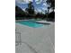 A community swimming pool surrounded by lounge chairs and lush greenery offers a relaxing outdoor space at 2592 Grassy Point Dr # 306, Lake Mary, FL 32746