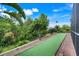 Beautiful backyard features lush landscaping, brick-lined turf, and an enclosed patio, creating a serene outdoor space at 3504 Cayugas Loop, St Cloud, FL 34772