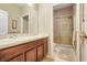 Bathroom featuring a double sink vanity and tiled shower, providing functionality and style at 3504 Cayugas Loop, St Cloud, FL 34772