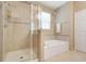 This bright bathroom offers a shower and a separate tub for your relaxation needs at 3504 Cayugas Loop, St Cloud, FL 34772