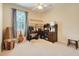 Comfortable bedroom area with a cozy chair, ceiling fan, and a desk near the window offering natural light at 3504 Cayugas Loop, St Cloud, FL 34772