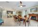 Open concept dining room with a fireplace, tile flooring, and connecting views to the kitchen at 3504 Cayugas Loop, St Cloud, FL 34772