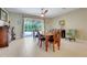 Elegant dining room with tile flooring, wood table, and sliding glass doors leading to outdoor patio at 3504 Cayugas Loop, St Cloud, FL 34772
