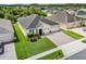 Beautiful single Gathering home featuring a lush lawn, well-manicured landscaping, and a brick paver driveway at 3504 Cayugas Loop, St Cloud, FL 34772