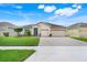 Charming single-story home with well-manicured lawn, brick driveway, and two-car garage, perfect for suburban living at 3504 Cayugas Loop, St Cloud, FL 34772