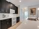 Close-up of a kitchen featuring dark cabinets, stainless steel appliances, and a stylish backsplash at 3504 Cayugas Loop, St Cloud, FL 34772