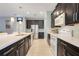 Well-equipped kitchen with dark cabinetry, stainless steel appliances, and a spacious countertop at 3504 Cayugas Loop, St Cloud, FL 34772