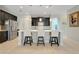 Modern kitchen with stainless steel appliances, a breakfast bar with seating, and stylish lighting at 3504 Cayugas Loop, St Cloud, FL 34772