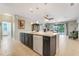 Open concept kitchen island with a breakfast bar, seamlessly flowing into the dining area and living spaces at 3504 Cayugas Loop, St Cloud, FL 34772