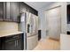 Modern kitchen features stainless steel refrigerator and sleek dark cabinets, a chef's delight at 3504 Cayugas Loop, St Cloud, FL 34772
